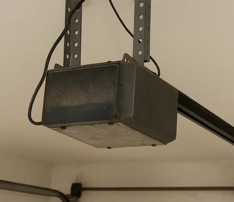Before garage door opener repair with visible damage and misalignment